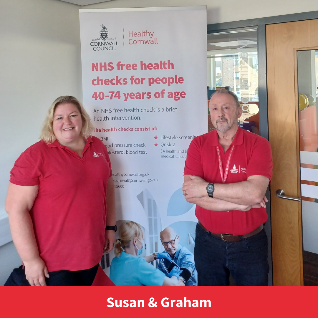 susan and graham from the health check team smile towards camera next to a healthy cornwall banner