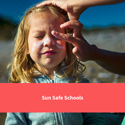 child having sun cream on, text reads "sun safe schools"