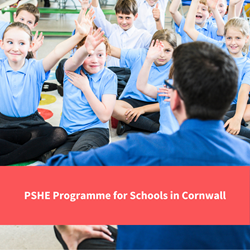 teacher sat in front students, students have hands up, text reads "PSHE programme for Schools in Cornwall"